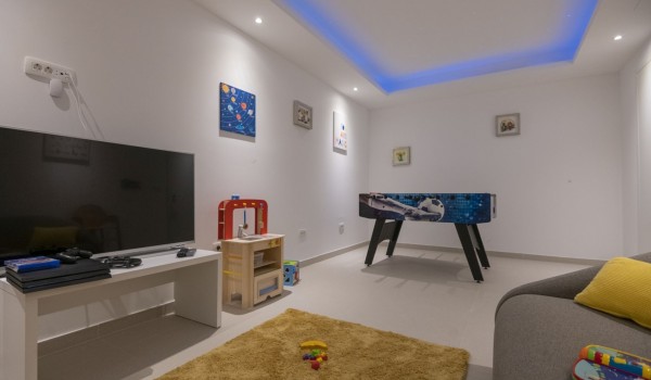 Room with children's facilities, foosball table, sofa and LCD TV in a luxury villa for a family vacation in Brela