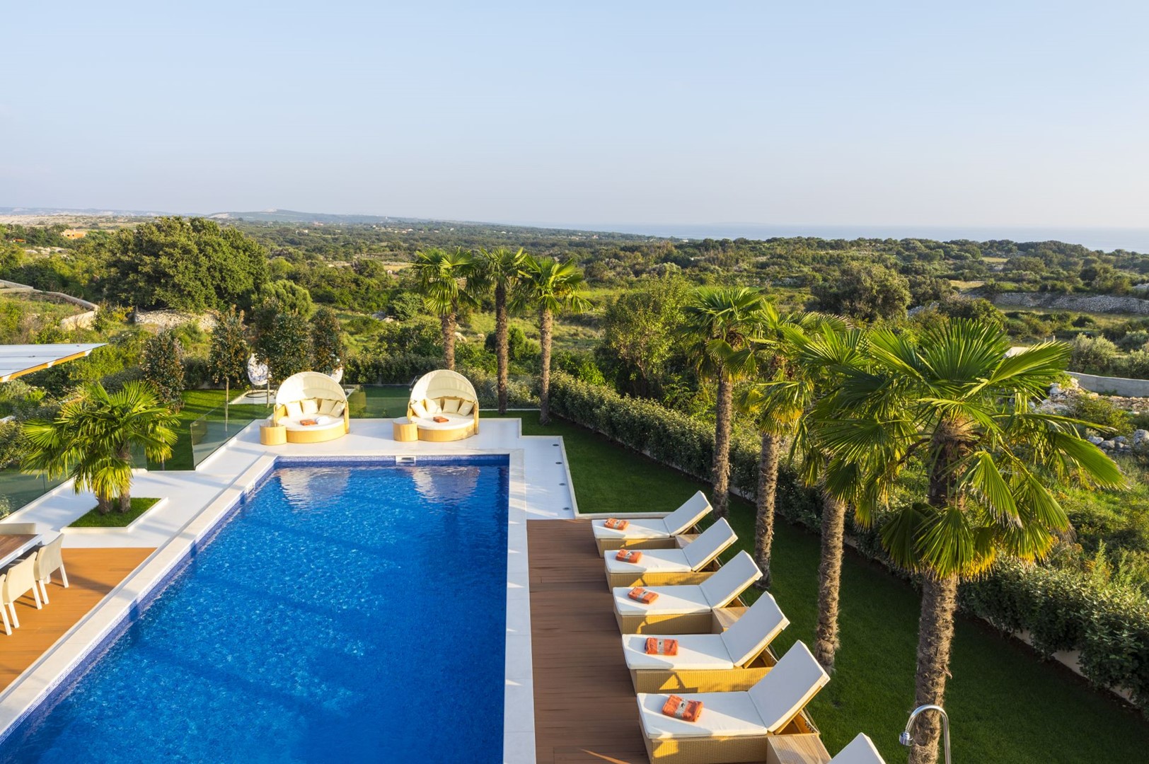 Private heated pool and sun loungers of a  Croatian luxury villa Hidden Hills for family vacation in Novalja