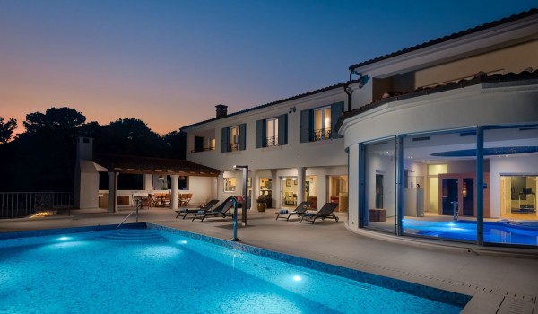 Terrace with private outdoor pool and deck chairs in the beachfront vacation villa with concierge service