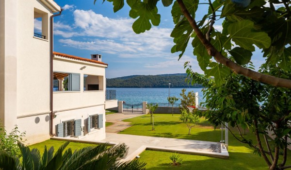 Landscaped garden in front of the Beachfront villa Sea Whisper with concierge service and indoor pool