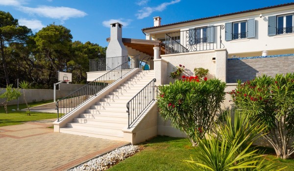 Paved road to the Croatian luxury family villa for vacation by the sea in Sibenik