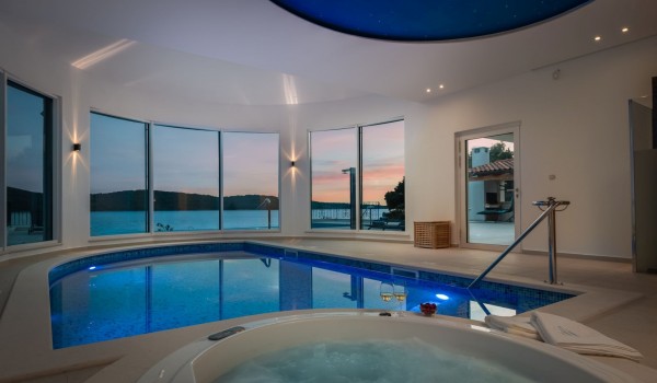Indoor heated pool and jacuzzi of the luxury beachfront villa for family vacation in Sibenik