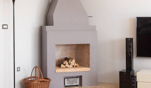 Traditional fireplace in the living room of the Luxury vacation villa with concierge service and wine cellar
