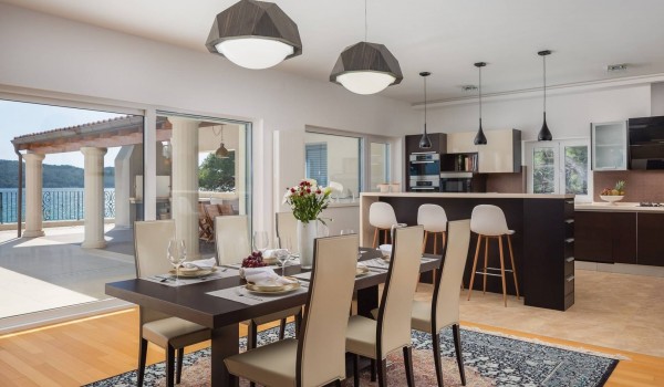 Dining table and kitchen in the Luxury seafront villa for vacation with friends