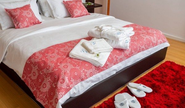 Queen size bed in bedroom of a luxury vacation villa on the beach in Sibenik