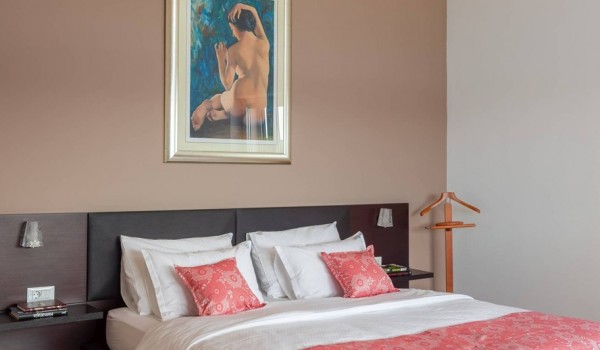 Queen size bed in bedroom of a luxury vacation villa on the beach in Sibenik