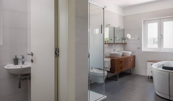 Bathroom with bathtub and shower in the luxury beachfront villa for family vacation in Sibenik