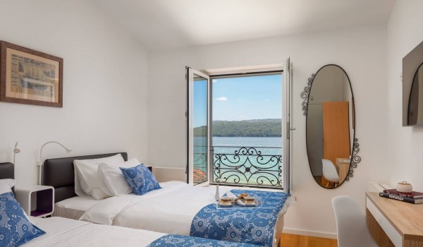 Twin beds in a bedroom of the luxury vacation villa at the beach in Sibenik