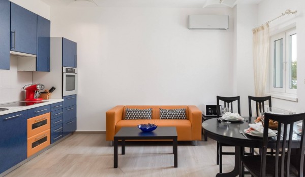 Kitchen, dining table and sofa in the Beachfront villa for family vacation in SIbenik with concierge service