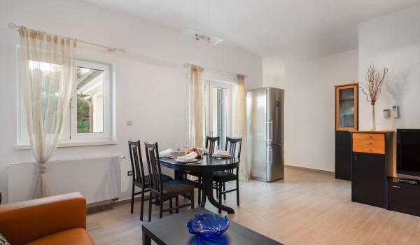 Kitchen, dining table and sofa in the beachfront villa for family vacation in SIbenik with concierge service