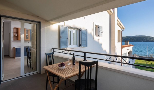 Seating area on a terrace with sea view in the luxury family villa with gym and sauna in Sibenik