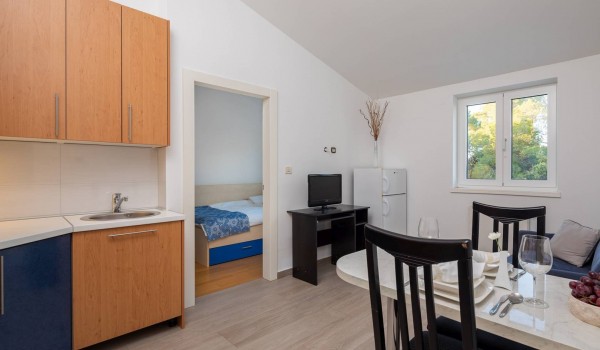 Living area with dining table in the luxury vacation villa overlooking the sea in Sibenik with concierge service