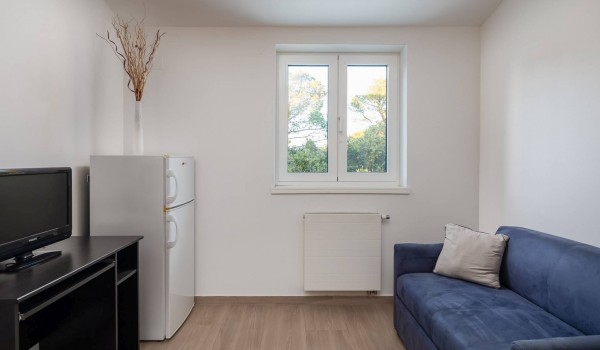 Sofa and TV in a suite of a luxury holiday villa at the beach in SIbenik with indoor heated pool