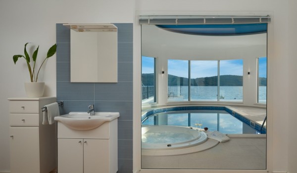Bathroom with view of the indoor pool and jacuzzi in a Sibenik luxury villa for vacation with friends and family