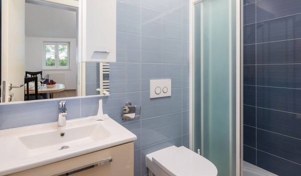 Bathroom with shower, sink and toilet in the luxury vacation villa at the beach in Sibenik