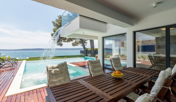 Outdoor dining area by the pool overlooking the sea in the vacation villa in Split with private parking and wi fi