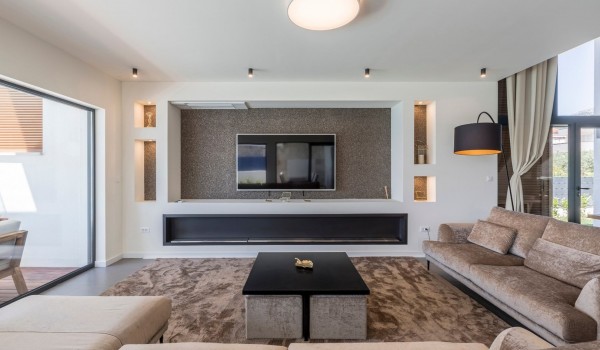 Living room with comfortable sofas and big TV in the modern vacation villa with private pool in Split