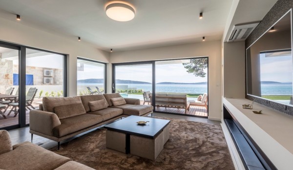 Living room with comfortable sofas and big TV in the modern vacation villa with concierge service in Split