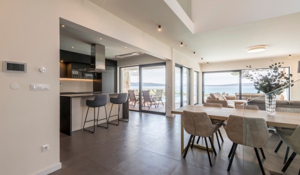 Dining table and kitchen of the family villa for vacation and rent in Kastela with concierge service