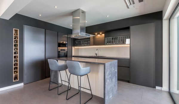 Modern kitchen with kitchen island and wine rack in the modern villa for rent with parking and Wi-Fi