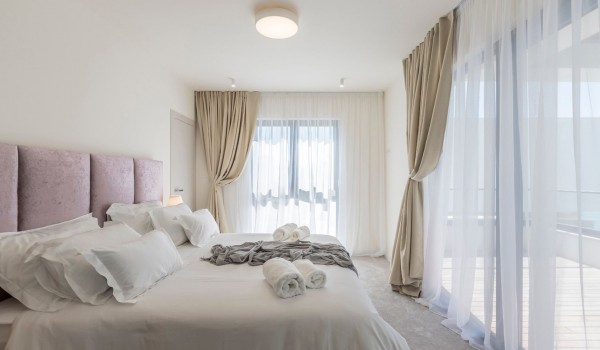 King size bed in the luxury bedroom of the vacation private rental villa with private pool in Kastela