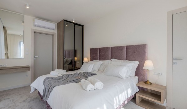 King size bed in the luxury bedroom of the vacation villa with private pool and concierge service in Kastela