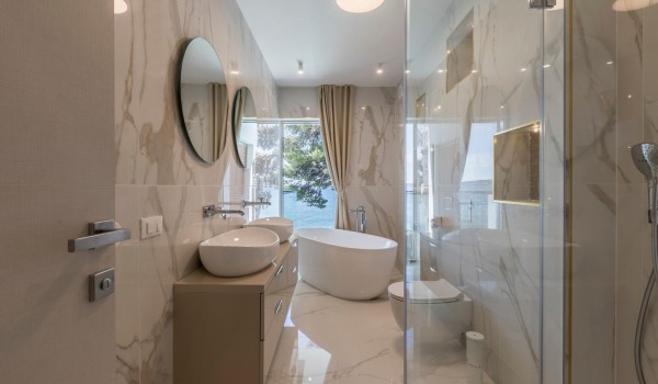 En suite bathroom with marble décor of the luxury beachfront villa Papillon with private pool with total privacy