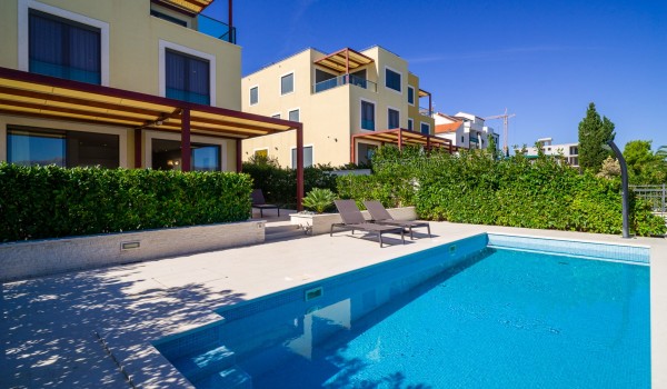 Sun beds by the private pool of a Croatian luxury family villa Ciovo Joy 3 by the sea with total privacy