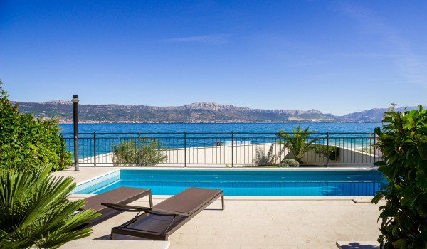 Sun beds by the private pool of a luxury family rental villa Ciovo Joy 3 by the sea with total privacy