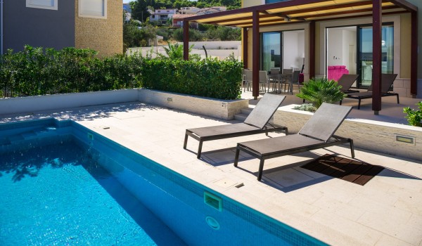 Sun beds by the private pool of a luxury family villa Ciovo Joy 3 by the sea with total privacy