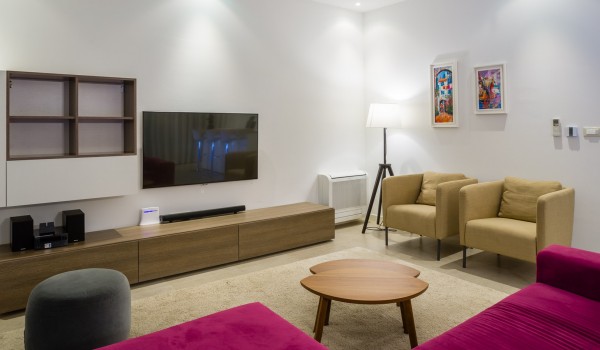 Magenta comfortable sofa and coffee table in a living room of a luxury holiday villa at the beach on Ciovo