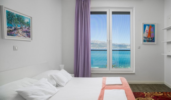 Double bed  in a bedroom of a luxury vacation villa with family and friends in Ciovo