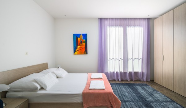 Double bed and floor-to-ceiling closet in a luxury beachfront villa with private pool and wifi