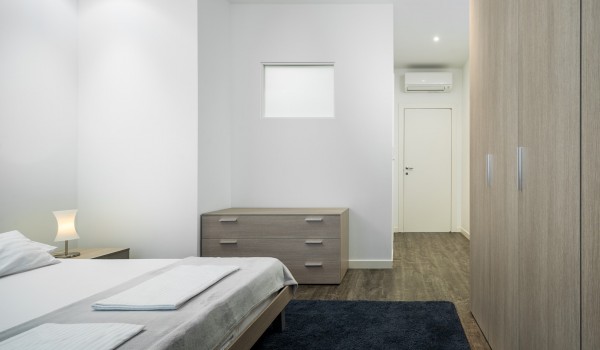 Double bed and floor-to-ceiling closet in a luxury beachfront villa with private pool and Wi-Fi