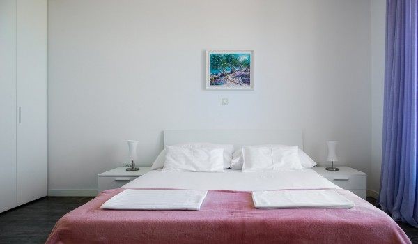 Double bed in a bedroom of a luxury vacation villa with family and friends in Ciovo with total privacy