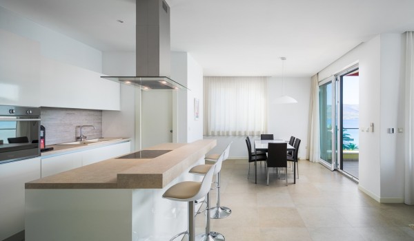 Dining table and kitchen island in a luxury vacation home for family vacation by the sea in Ciovo