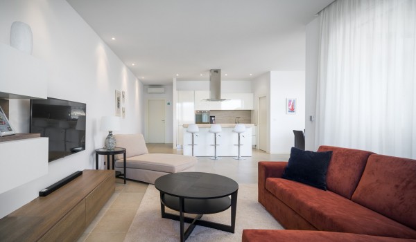 Living room with brown sofa and beige daybed in a luxury beachfront villa for vacation with friends in Ciovo