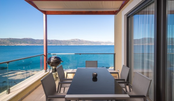 Outdoor table and grill on the balcony of a luxury family villa Ciovo Joy 3 with sea view in Ciovo