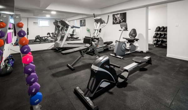 Private gym with various equipment in a luxury beachfront villa for vacation with friends in Ciovo
