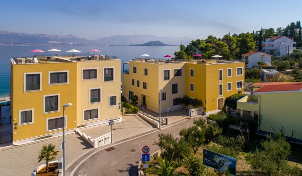 View of an entrance and parking place of a luxury family villa with private pool and sea view