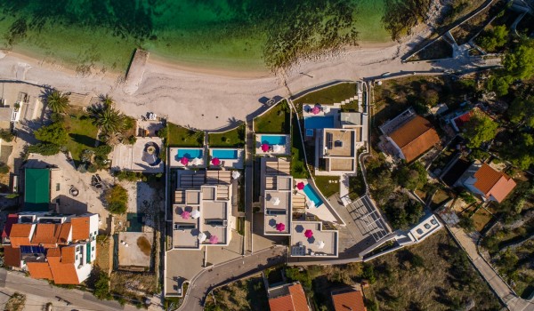Aerial view of the bay and luxury beachfront villa Ciovo Joy 3 with private pool and gym in Ciovo