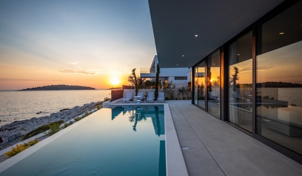 View of the private heated pool and the sea from the outdoor terrace of the Croatian luxury villa for rent Supreme Rogoznica 2 in Rogoznica