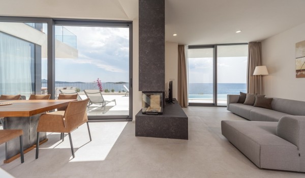 The interior of the luxury villa Supreme Rogoznica 2 with living room and dining room and access to the outdoor terrace
