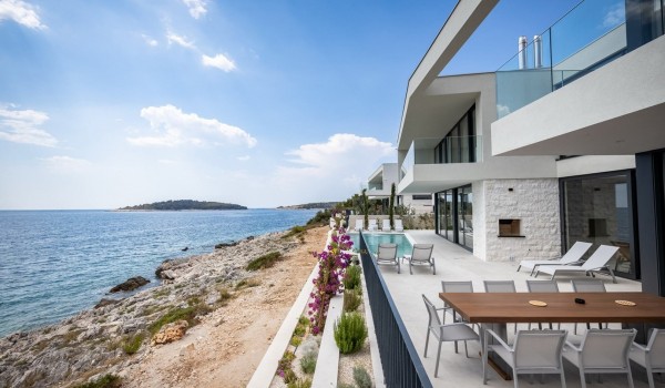 Outdoor terrace with dining table, private pool and sunbeds in luxury vacation villa Supreme Rogoznica 2 in Rogoznica