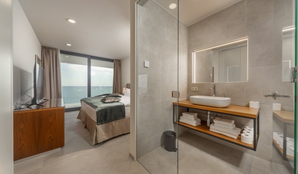 Bedroom with en suite bathroom, double bed and sea view in a luxury private rental villa with private pool in Rogoznica