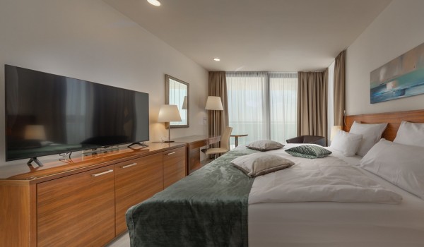 Bedroom with desk and chair, LCD TV and double bed in luxury villa by the sea Supreme Rogoznica 2 in Rogoznica