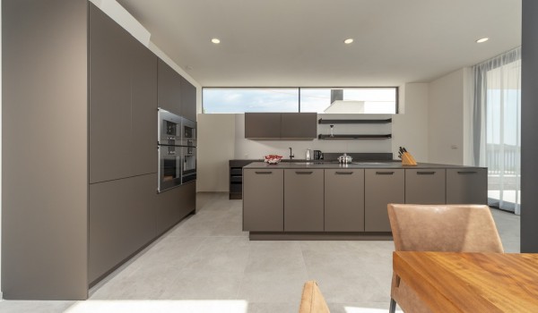 A view of the kitchen equipped with an oven, fridge and kitchen island in the luxury holiday villa Supreme Rogoznica 2 in Rogoznica