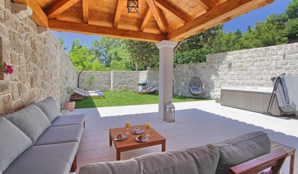 Private jacuzzi in a fenced garden, with outdoor shower and terrace with a stone gazebo and seating area in front of Dubrovnik exclusive villa for 8