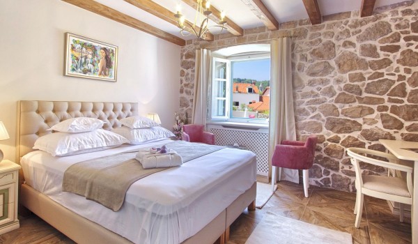King size bed in a bedroom of a Croatia luxury vacation villa for rent with jacuzzi and private garden near Dubrovnik