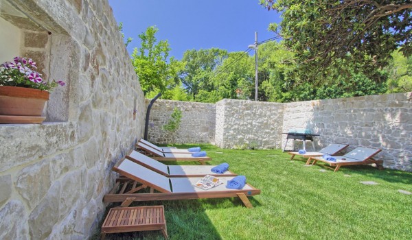 Private fully fenced estate with a garden and sun loungers of the historic stone villa for rent and vacation near Dubrovnik